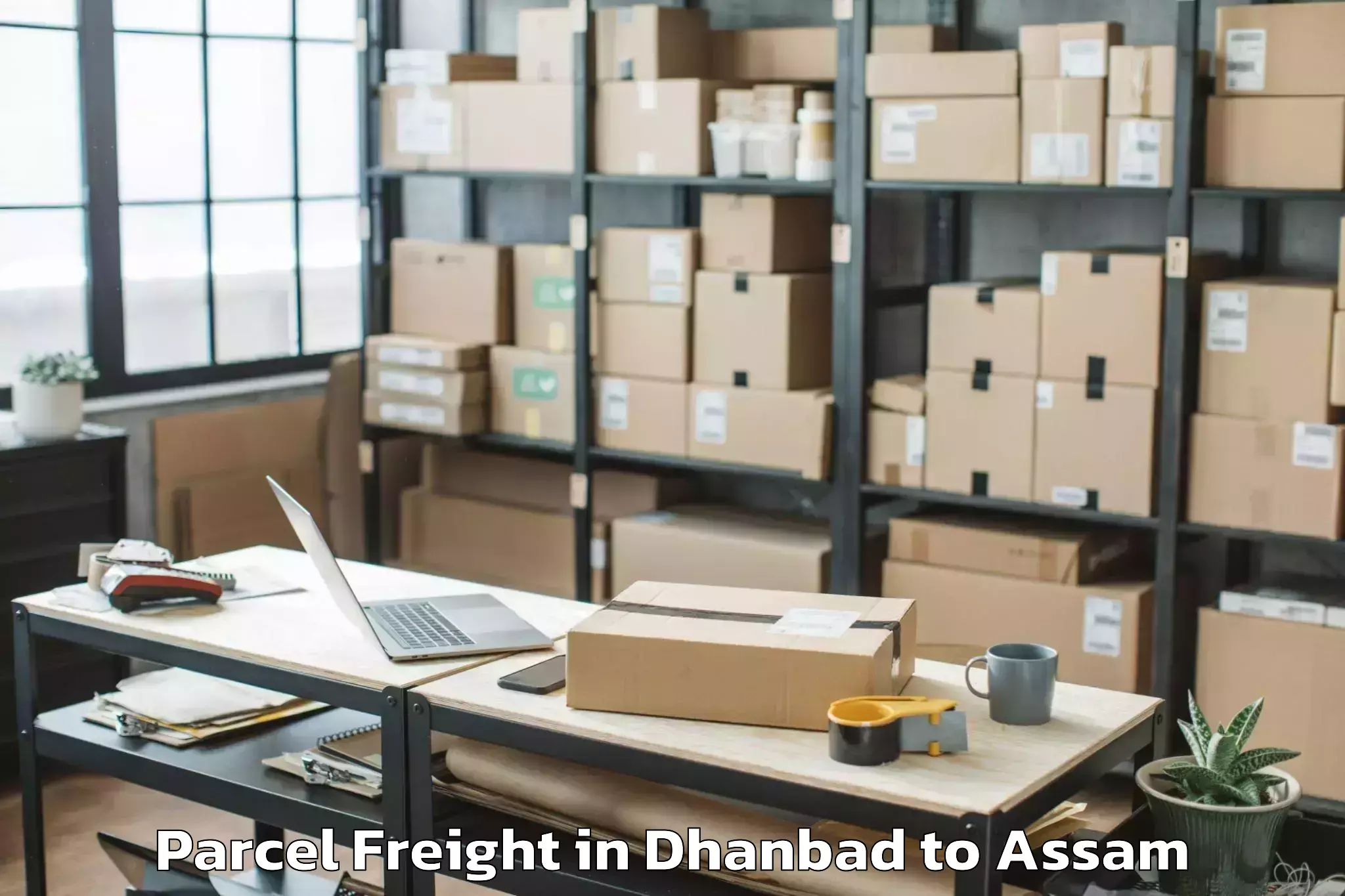 Book Dhanbad to Golokganj Pt Parcel Freight Online